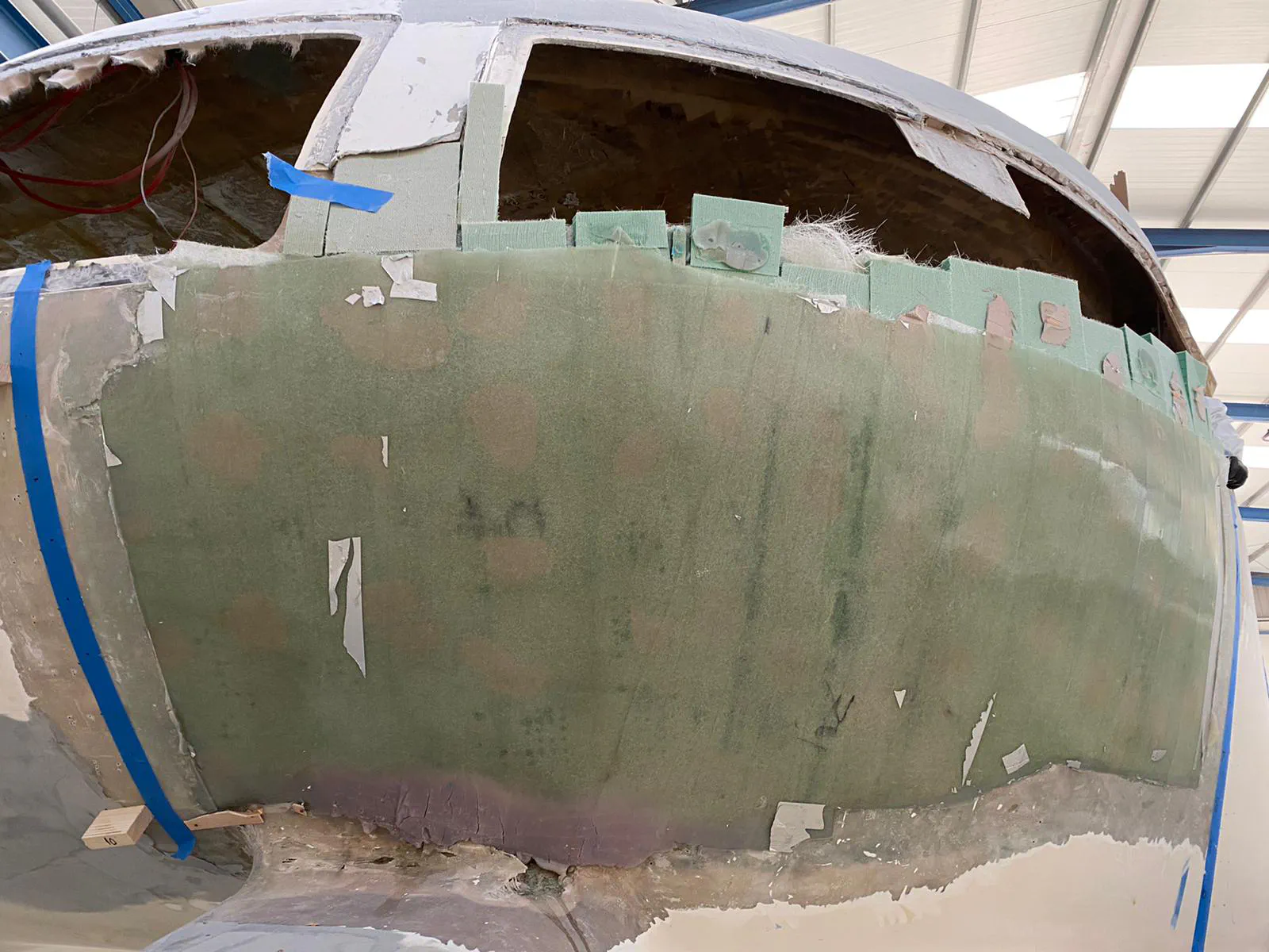 The aft cabin during the fiberglass application process, with the mold ensuring the correct shape.