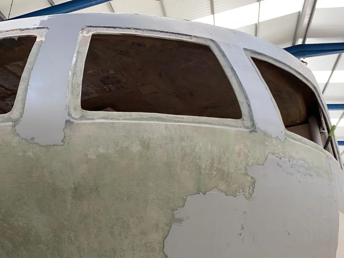 The completed fiberglass repair on the aft cabin, showing a smooth, curved surface.