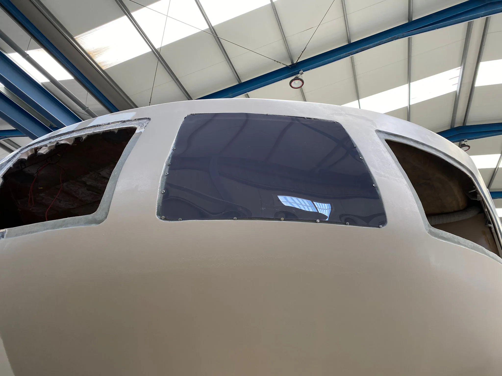 The result of the thermoforming test on the new window, showing a slight curve.