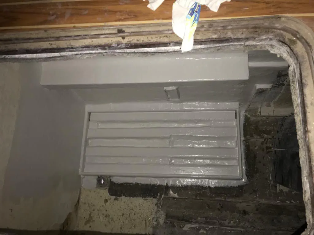 Newly built and painted white supports for the grey water tanks, installed in the engine room.