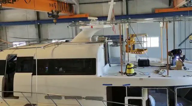 The installation and welding of the stainless steel superstructure for the solar panels on the deck of the boat.