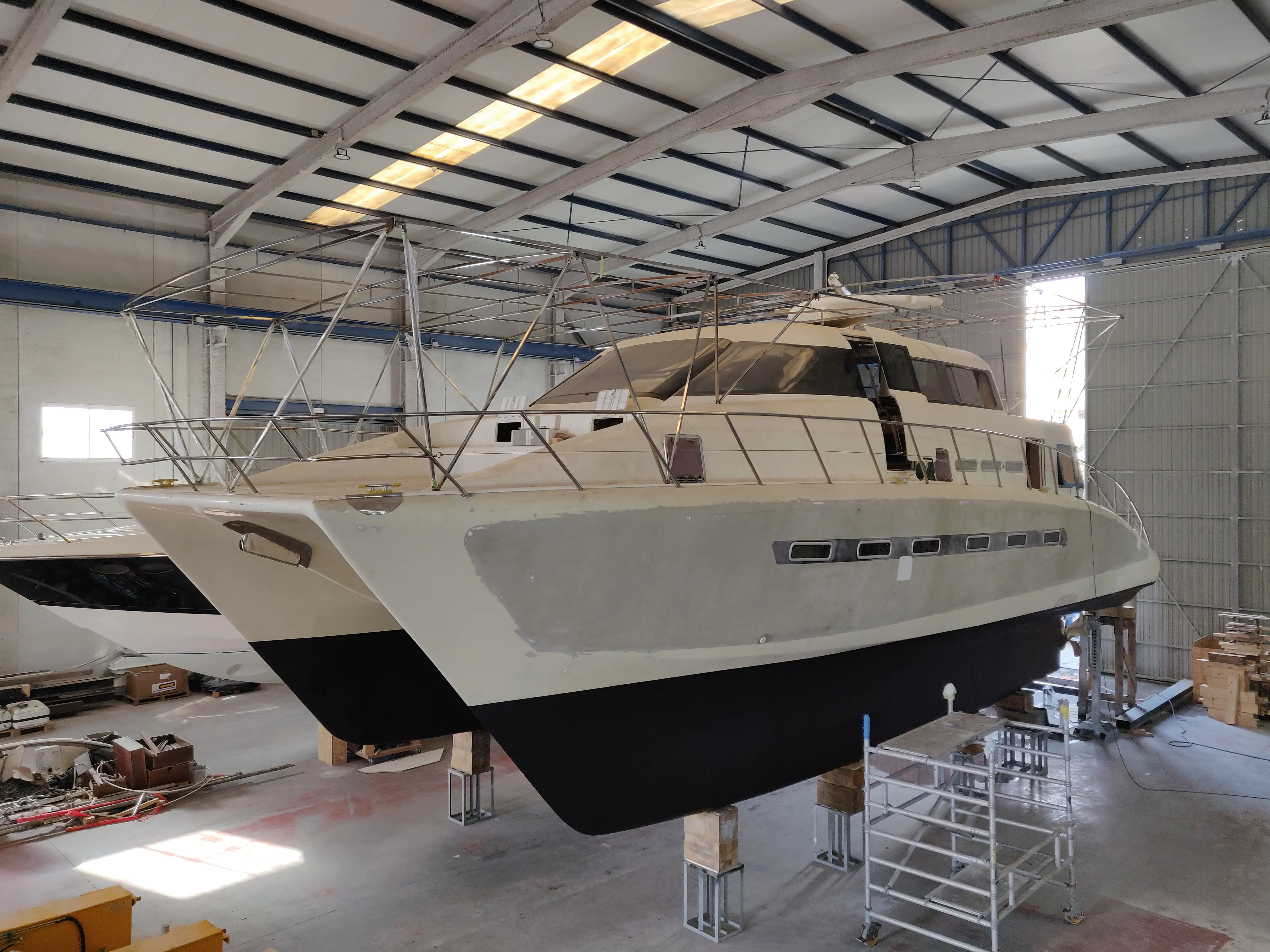 The hull of the boat after the application of black antifouling paint.