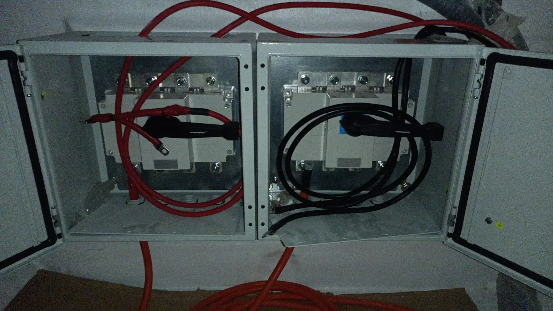 The main switch disconnectors and bus bars for the 96V DC system installed in metal cabinets.