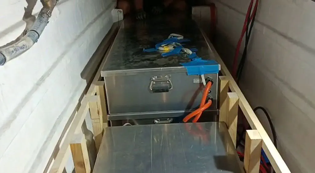 Three of the four battery boxes installed in the port hull, ready for wiring.