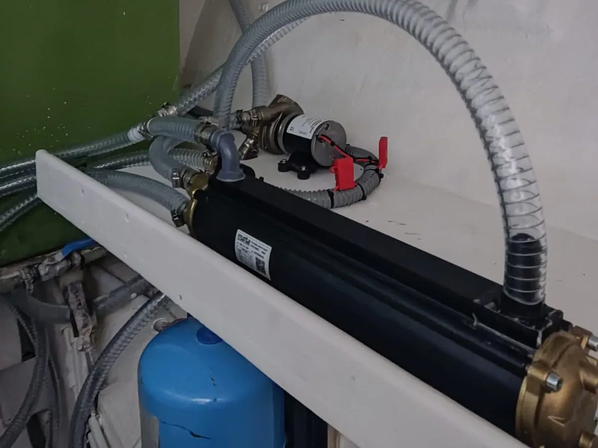 The completed plumbing for the motor cooling system, showing the sea water pump next to the heat exchanger.