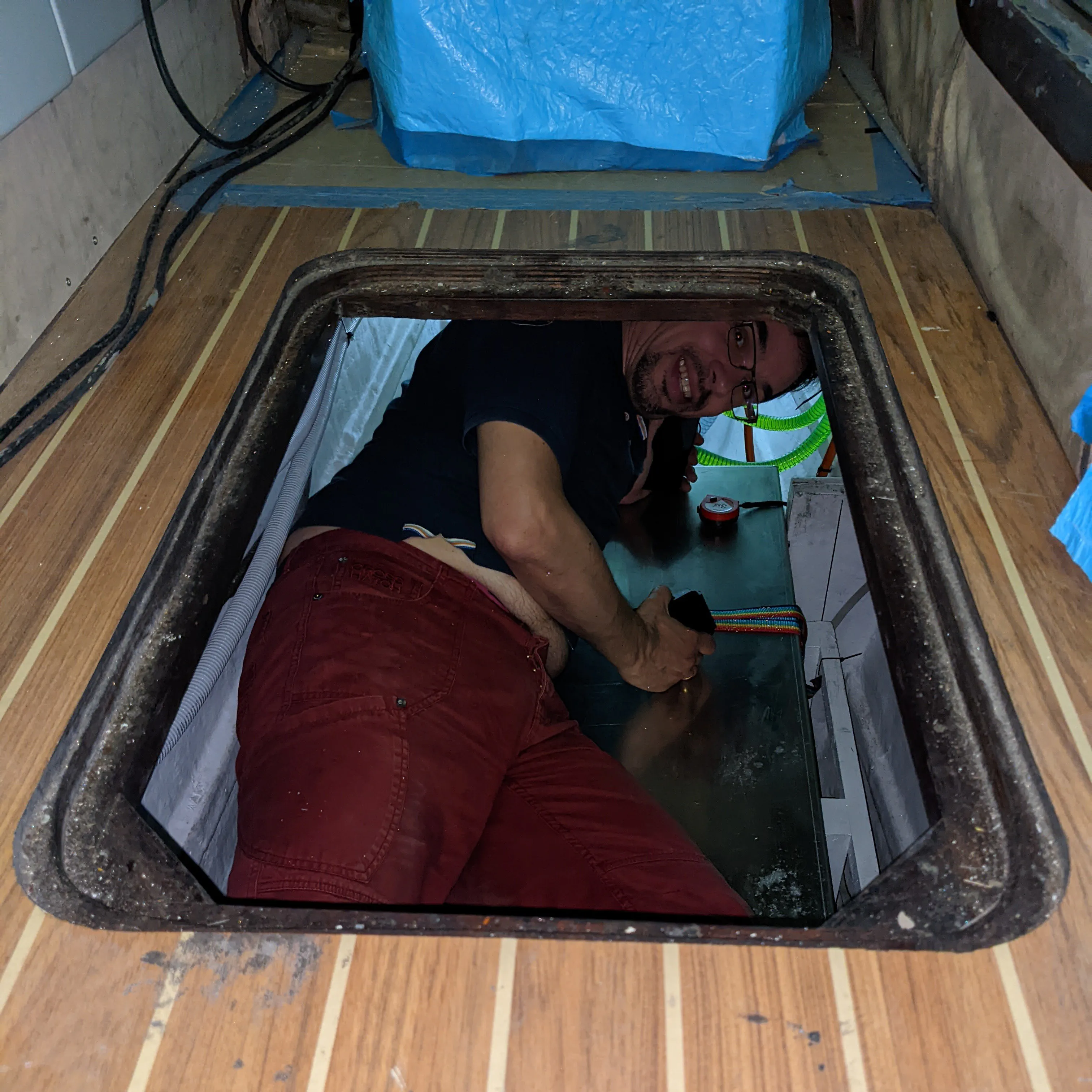 View of the port side engine room showing the battery boxes that need to be removed.