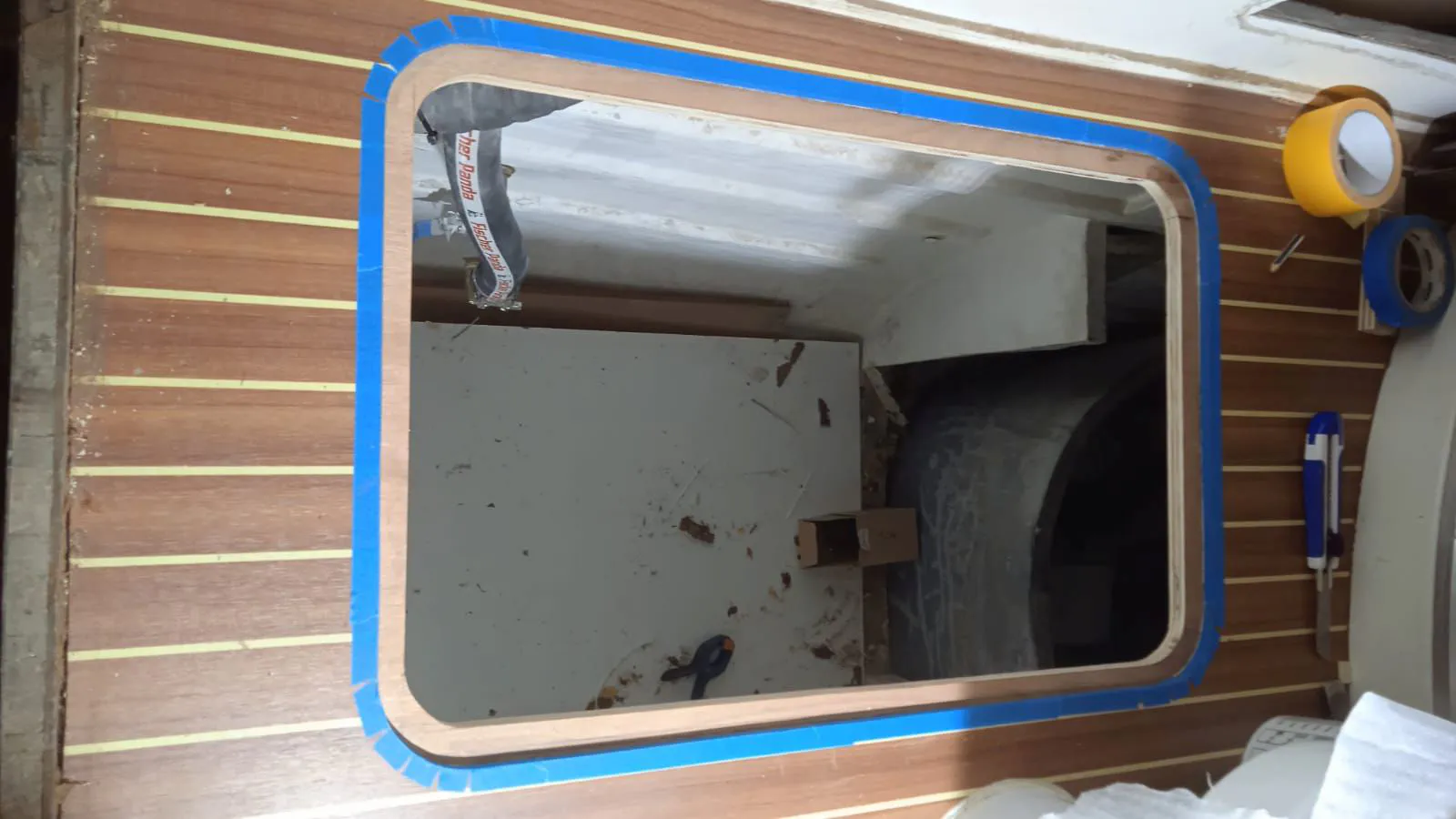 The newly cut opening in the bathroom floor for motor access.