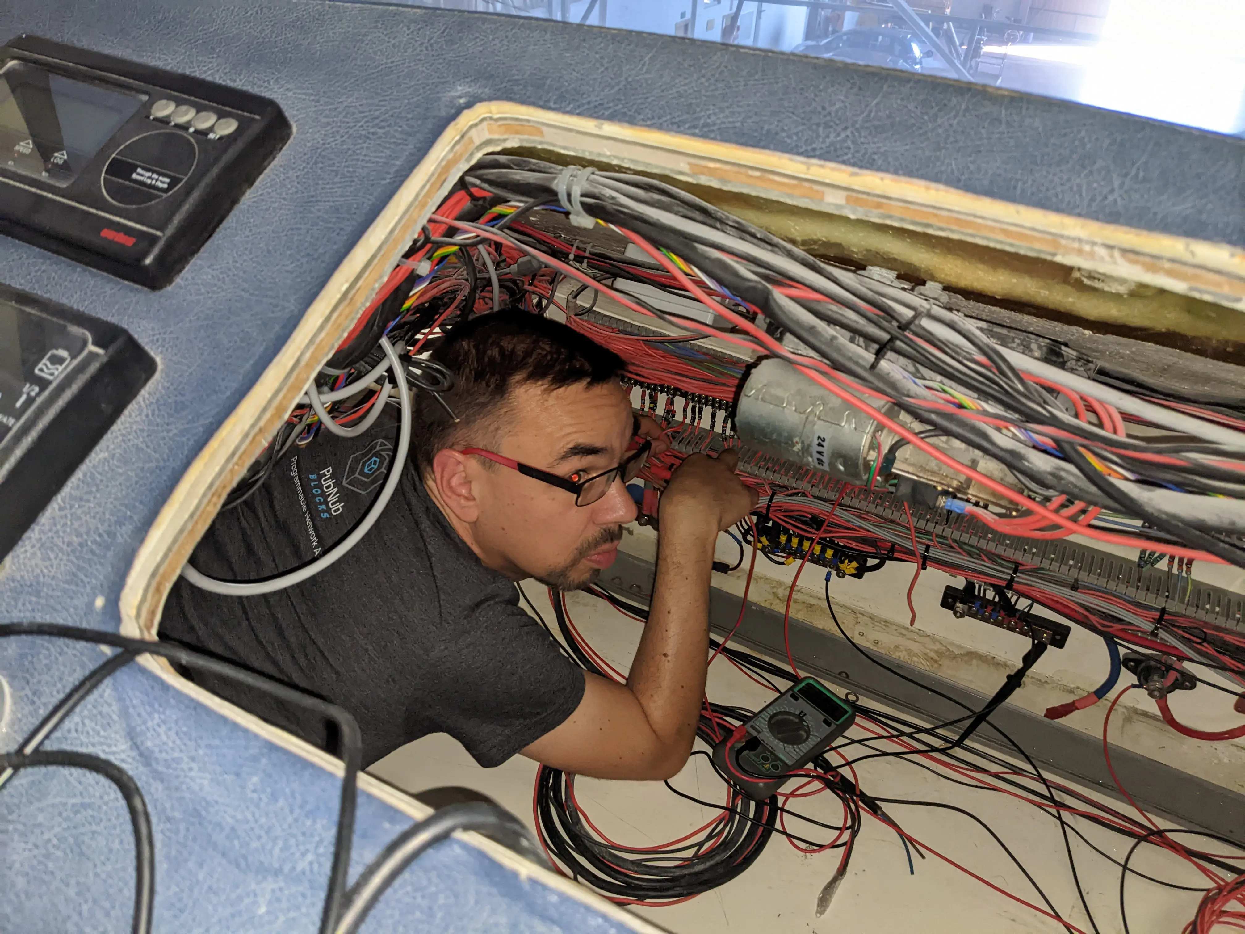 Documenting Electrical Systems Jerome following wires in tight spaces to document electrical wiring.