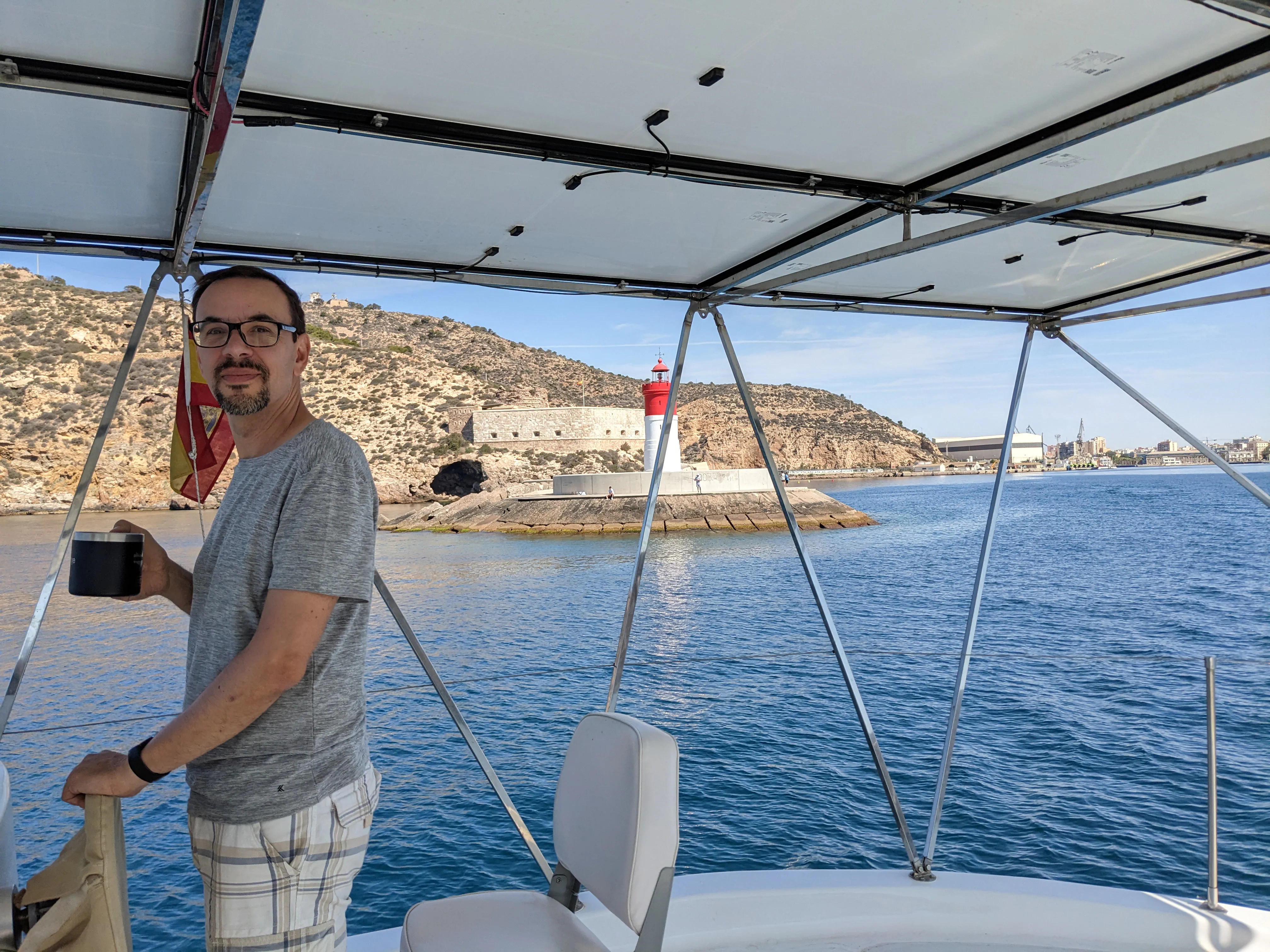 Jerome at the helm passing the harbor red light Jerome at the helm passing the harbor red light
