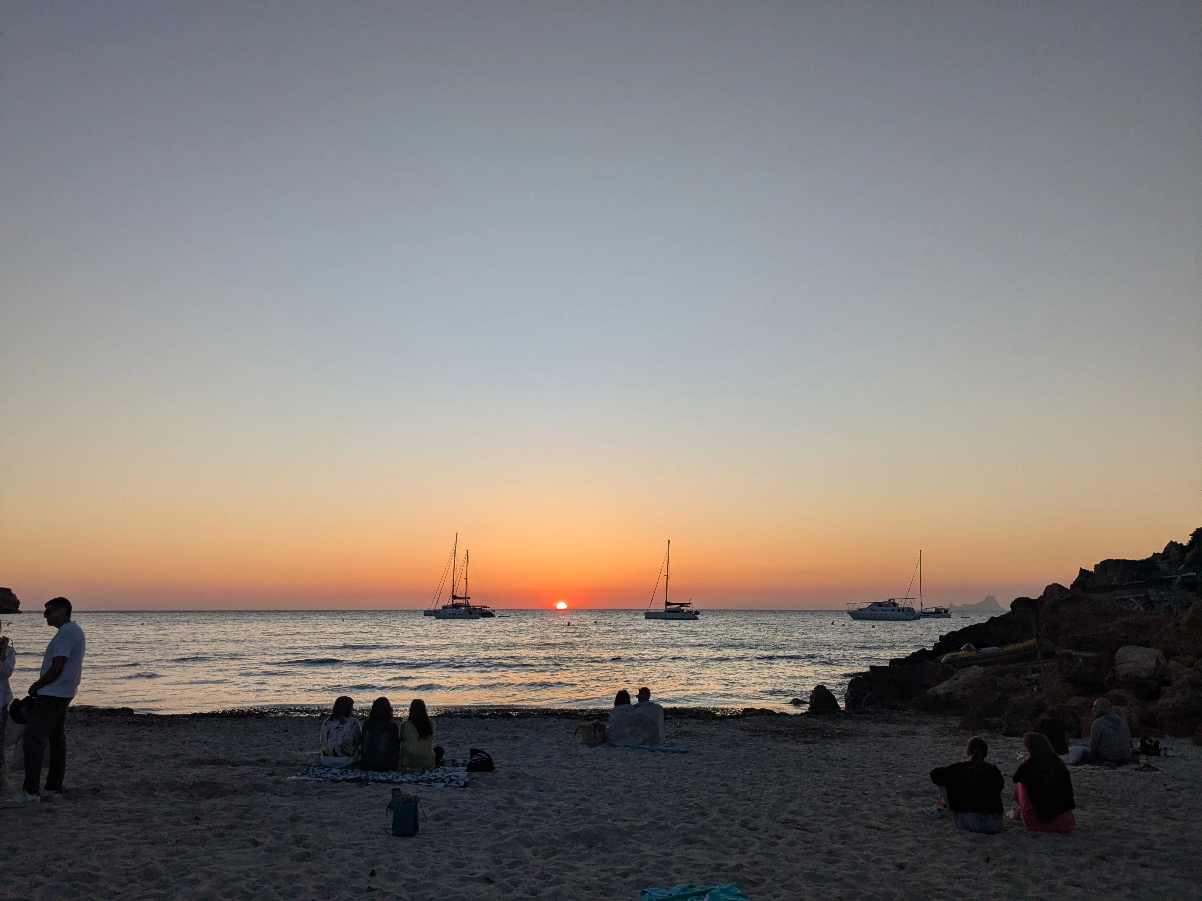 Sunset at Cala Saona People gathered on the beach to watch the sunset